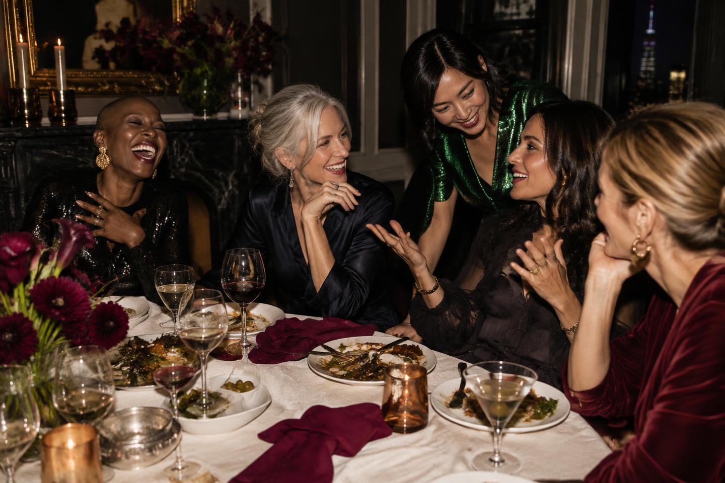 Women in spirited conversation around an intimate dinner table